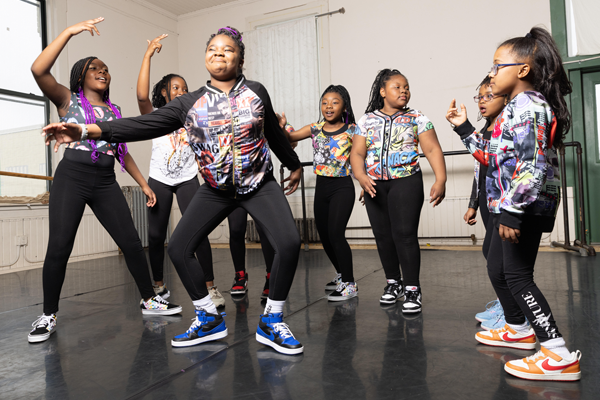 A group of young girls doing hip hop dancing in a studio.